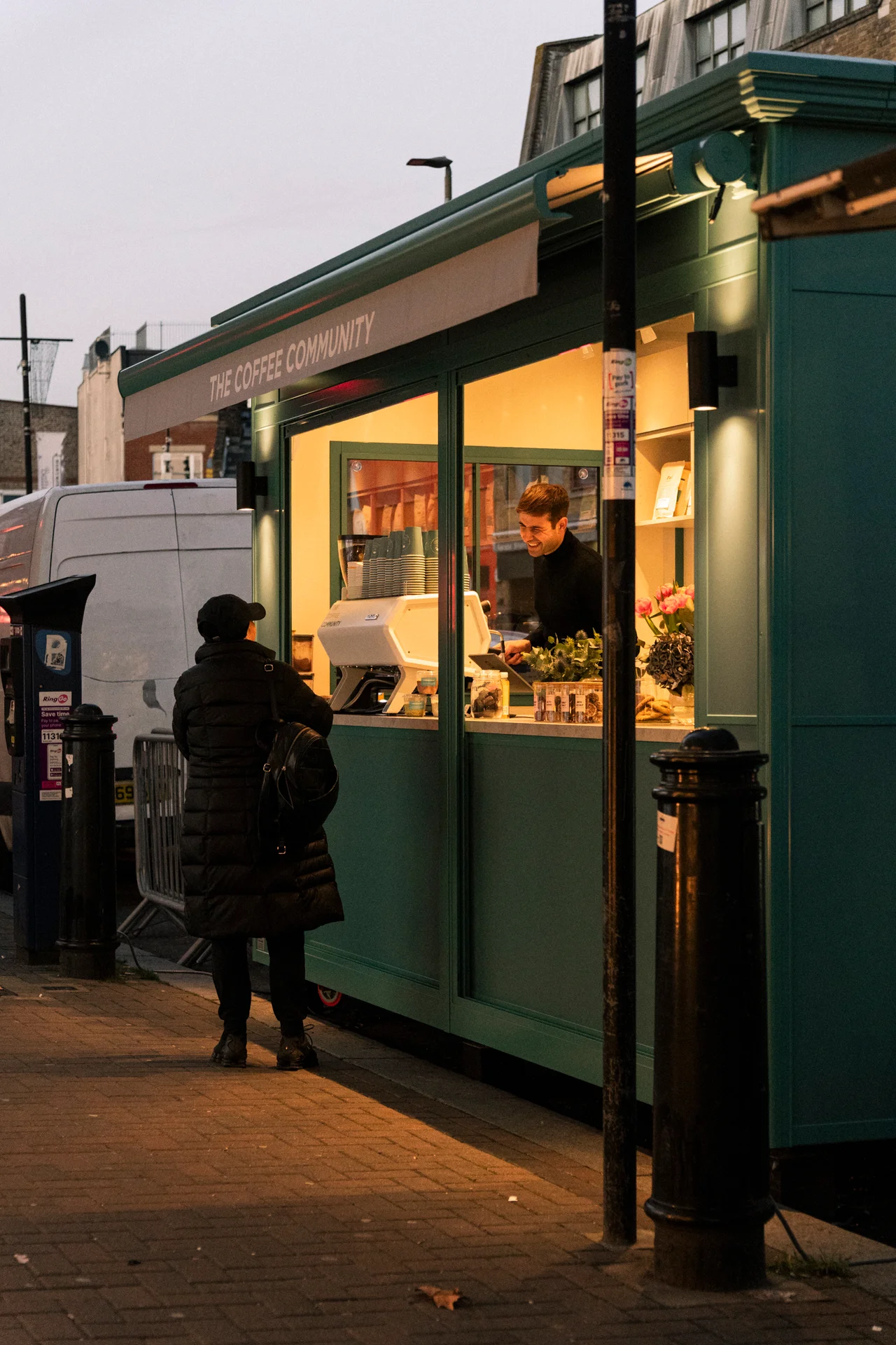The coffee kiosk on the corner, served at dusk