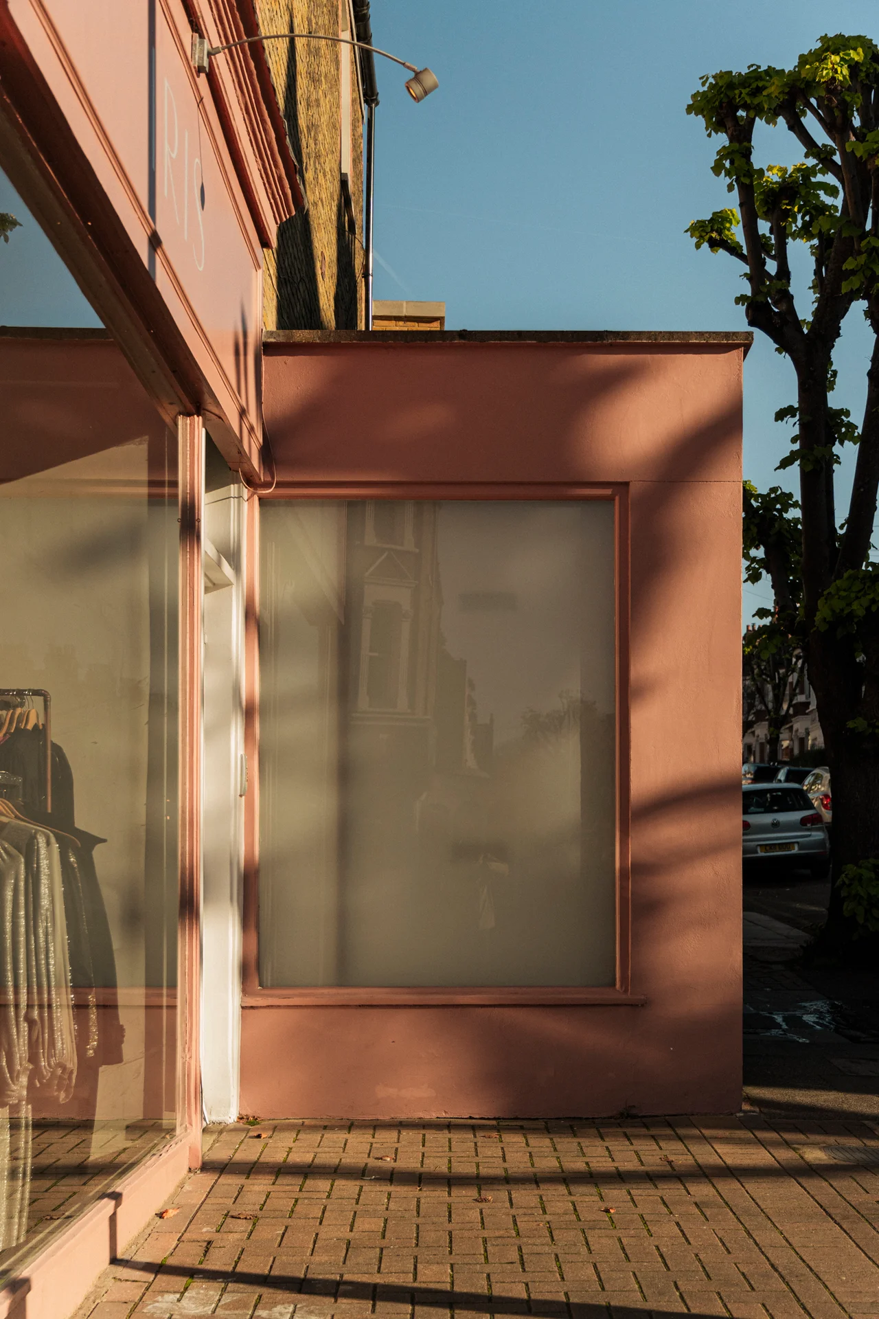 Pink storefront corner in late afternoon light
